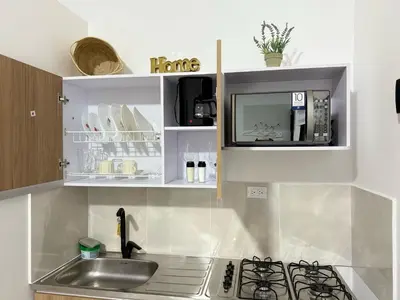 a kitchen with a sink and a microwave at Casa Bendita 201 Espectacular in Medellín