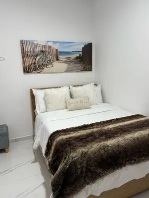 a bedroom with a bed with a brown blanket at Casa Bendita 201 Espectacular in Medellín