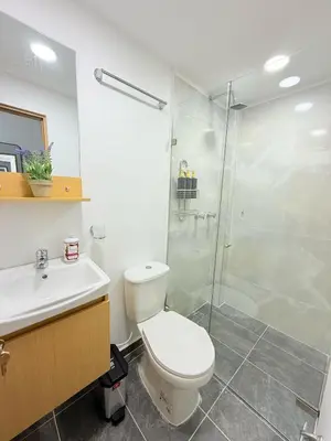 a bathroom with a toilet and a glass shower at Casa Bendita 201 Espectacular in Medellín