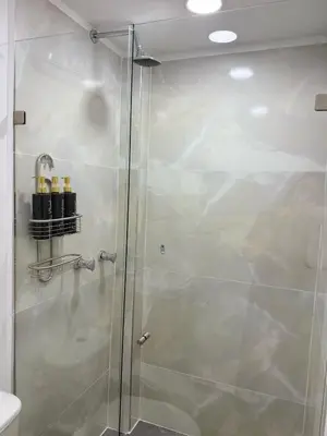 a shower with a glass door in a bathroom at Casa Bendita 201 Espectacular in Medellín