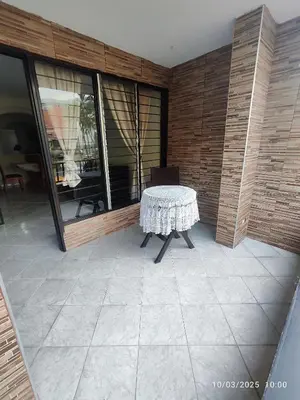 a table sitting on a patio with a room with windows at Comoda Casa en Itagüí, cerca de Medellín! Ideal para Familias y Grupos in Itagüí