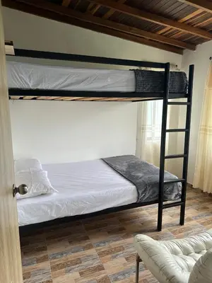 a bedroom with two bunk beds and a couch at Casa Campestre in Santa Bárbara
