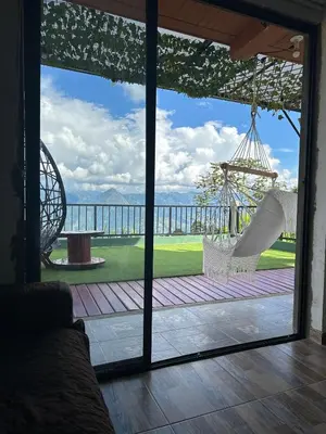 a room with a view of a patio with swings at Casa Campestre in Santa Bárbara