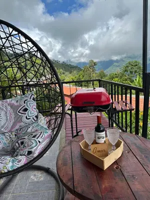 a table with a bottle of wine on a balcony at Casa Campestre in Santa Bárbara