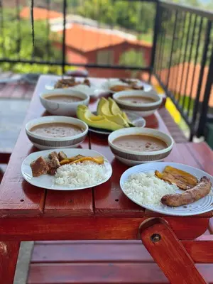 a wooden table with plates of food on it at Casa Campestre in Santa Bárbara