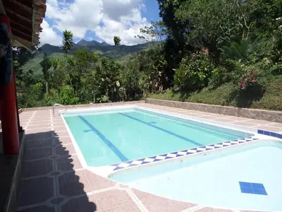 a large swimming pool with a view of the mountains at FINCA ARCANOS CELESTe in Barbosa