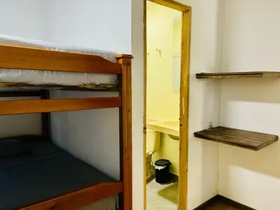 a room with two bunk beds and a mirror at Finca Campestre El Patujo in Doradal