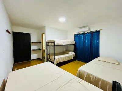 a room with two beds and a bunk bed at Finca Campestre El Patujo in Doradal