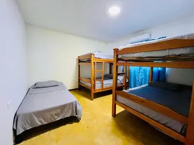 a room with two bunk beds and a bed at Finca Campestre El Patujo in Doradal