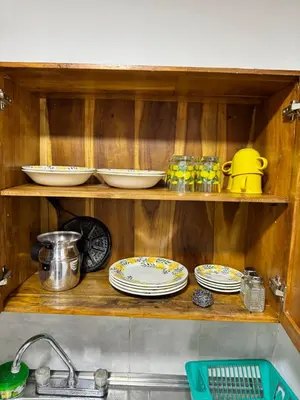 a kitchen counter with plates and dishes on a shelf at Pedacito de cielo in Jardin