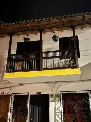 a building with a balcony with two lights on it at Pedacito de cielo in Jardin