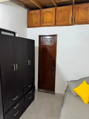 a bedroom with a bed and a wooden door at Pedacito de cielo in Jardin