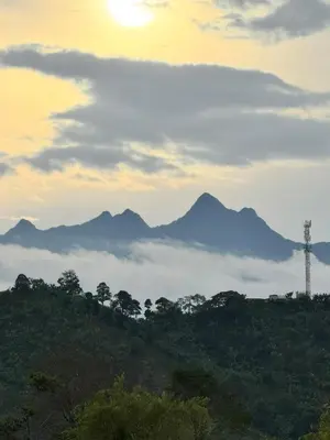 a view of a mountain range with the sun and clouds at Pedacito de cielo in Jardin