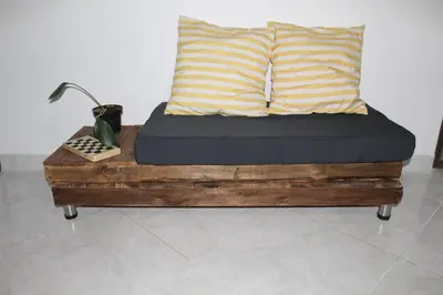 a wooden bed with two pillows on top of it at Pedacito de cielo in Jardin