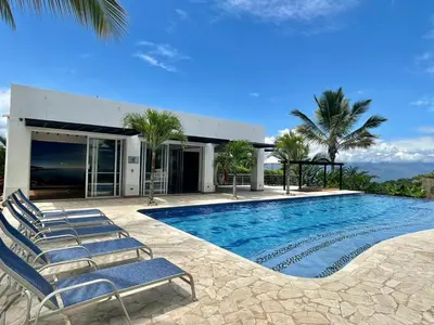 a swimming pool with chairs in front of a house at Finca La Mediterránea en San Jerónimo in San Jerónimo
