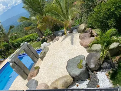 a swimming pool with palm trees and a resort at Finca La Mediterránea en San Jerónimo in San Jerónimo