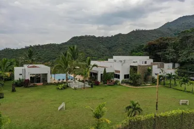 a house with a large yard in front of a mountain at Finca La Mediterránea en San Jerónimo in San Jerónimo