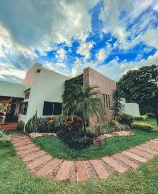 a house with a palm tree in front of it at Finca La Mediterránea en San Jerónimo in San Jerónimo