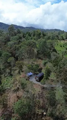 an aerial view of a field with a truck at Tiny House Minimalista en la Naturaleza cerca a El Retiro y La Ceja in El Retiro