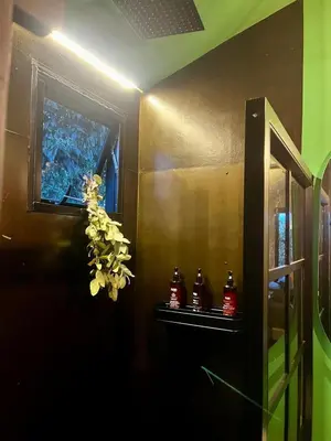a bathroom with a window and a shelf with bottles at Tiny House Minimalista en la Naturaleza cerca a El Retiro y La Ceja in El Retiro