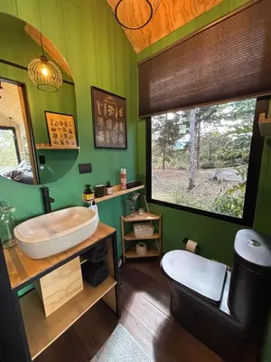 a green bathroom with a tub and a sink at Tiny House Minimalista en la Naturaleza cerca a El Retiro y La Ceja in El Retiro
