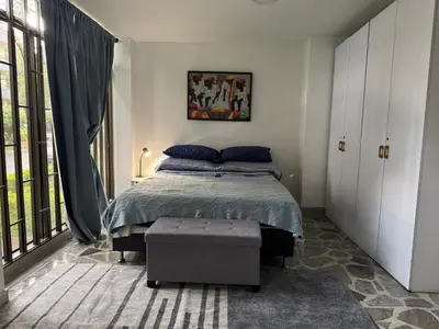 a bedroom with a bed and a large window at Nice place to stay in Medellín