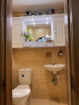 a bathroom with a toilet and a sink at Nice place to stay in Medellín