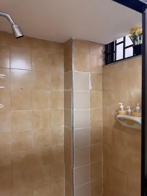 a shower with a glass door in a bathroom at Nice place to stay in Medellín