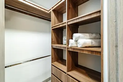 a walk in closet with wooden shelves and towels at Apartamentos Medellín Caribe Suite in Medellín
