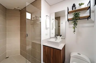 a bathroom with a sink and a toilet and a shower at Apartamentos Medellín Caribe Suite in Medellín