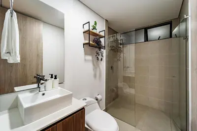 a bathroom with a toilet and a sink and a shower at Apartamentos Medellín Caribe Suite in Medellín