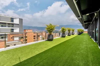 a balcony with green grass and plants on a building at Apartamentos Medellín Caribe Suite in Medellín