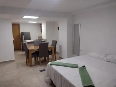 a room with a table and chairs and a bed at Apartamento La Paz in Envigado