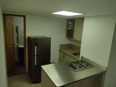 a kitchen with a black refrigerator and a counter top at Apartamento La Paz in Envigado
