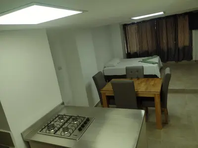 a kitchen and dining room with a stove and a table at Apartamento La Paz in Envigado