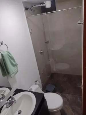a bathroom with a shower and a toilet and a sink at Apartamento La Paz in Envigado