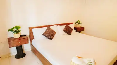 a bedroom with a white bed with two night stands at Oru Forest Retreat & Eco Lodge, just 15 minutes from the airport in Envigado