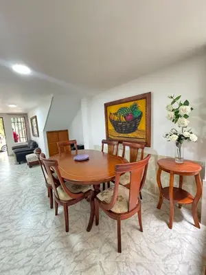a dining room with a wooden table and chairs at Apartamento Edificio Parques Del Trianon in Envigado