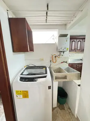 a small kitchen with a sink and a refrigerator at Apartamento Edificio Parques Del Trianon in Envigado