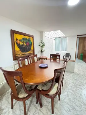 a dining room with a wooden table and chairs at Apartamento Edificio Parques Del Trianon in Envigado