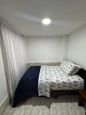 a bedroom with a bed and a window at Apartamento Edificio Parques Del Trianon in Envigado
