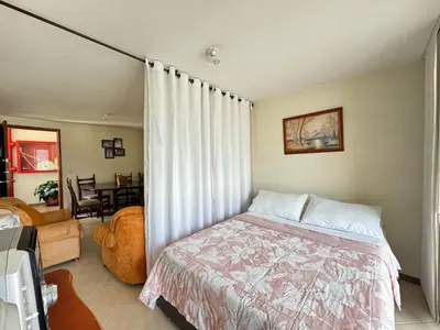 a bedroom with a bed in a room with a window at Cantabria in Manizales