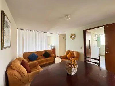 a living room with a table and a couch at Cantabria in Manizales