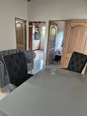 a meeting room with a table and two chairs at Apartamento Super Lindo in Medellín