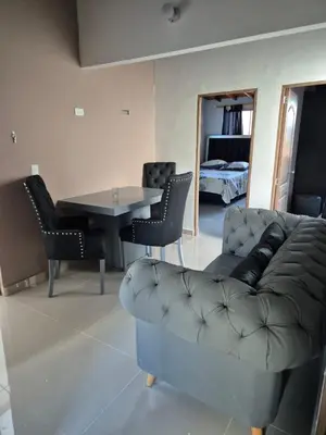 a living room with a couch and a table at Apartamento Super Lindo in Medellín