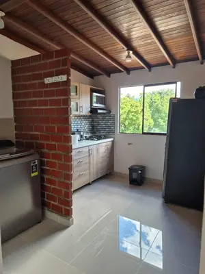 a kitchen with a brick wall and a brick pillar at Apartamento Super Lindo in Medellín