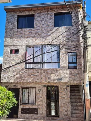 a brick building with glass windows on it at Apartamento Super Lindo in Medellín