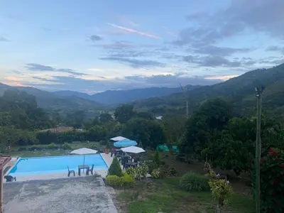 a view of a swimming pool with mountains in the background at Finca Villa Andrea 1h20min desde Medellín Niquía in Santa Rosa de Osos