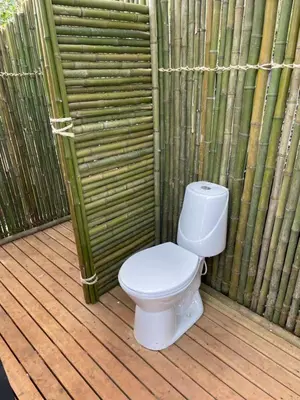 a white toilet sitting on a wooden deck at Glamping Resort Jonico Finca in Chinchiná