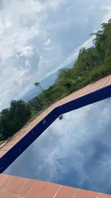 a reflection of the sky in a pool of water at Glamping Resort Jonico Finca in Chinchiná